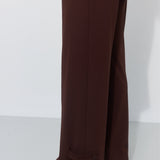Brązowe, szerokie spodnie damskie z guzikami na nogawkach, stylowe i wygodne, idealne na co dzień